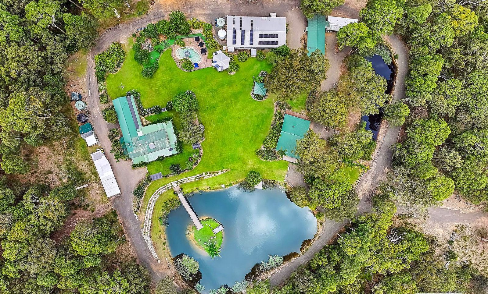 Aerial view of the house, lodge, dams and bushland at Wyee