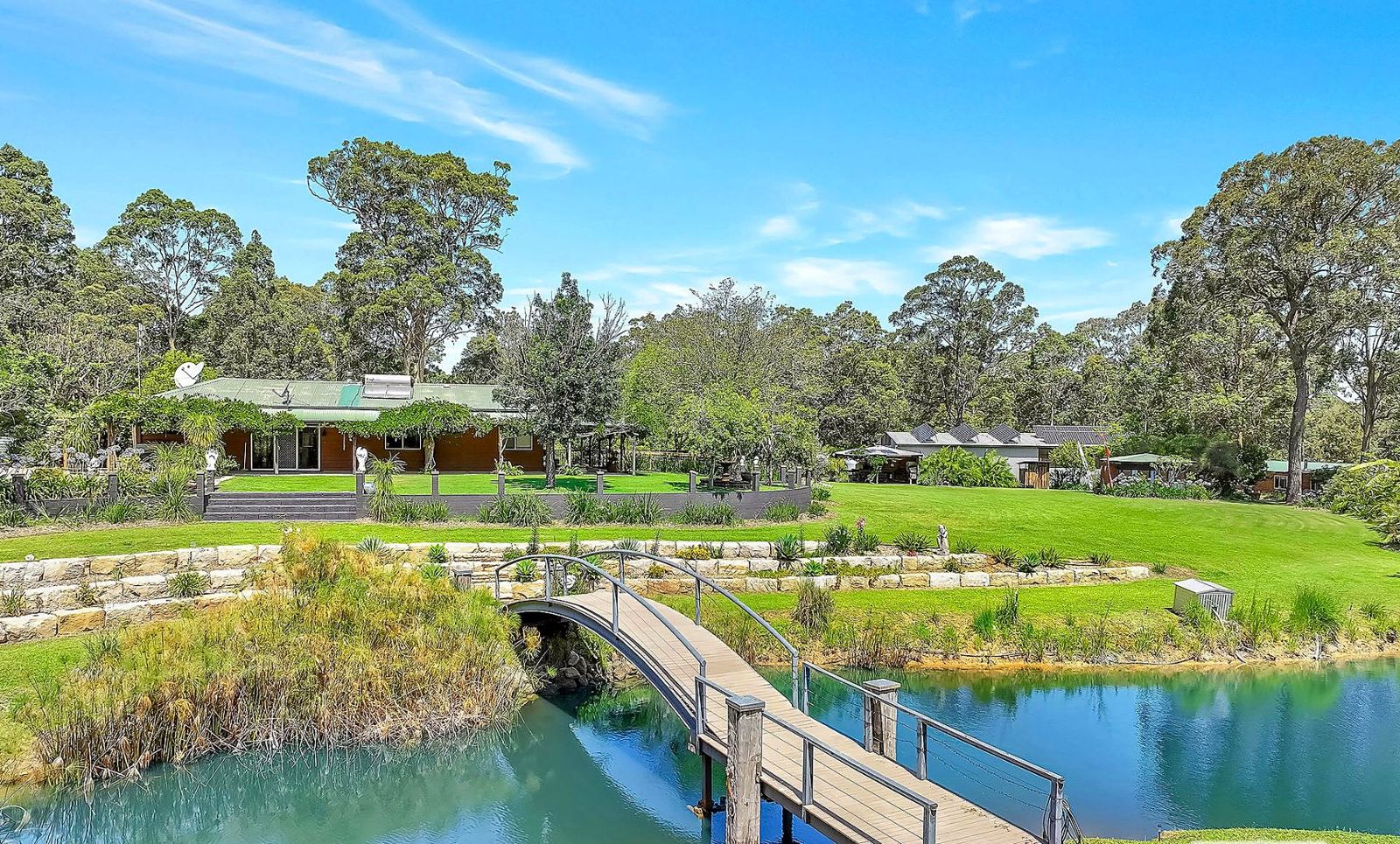 The bridge over the billabong, with the house and bushland beyond