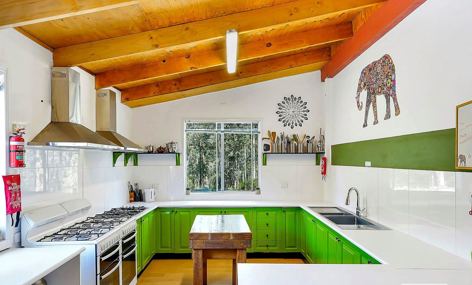 The commercial kitchen with its green cupboards